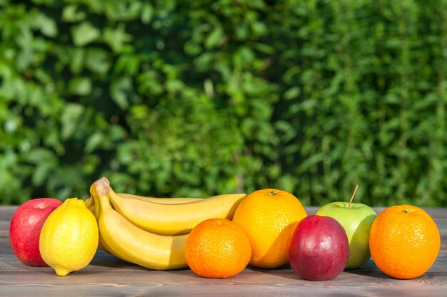 Fruits sur une table en bois sur fond de nature.