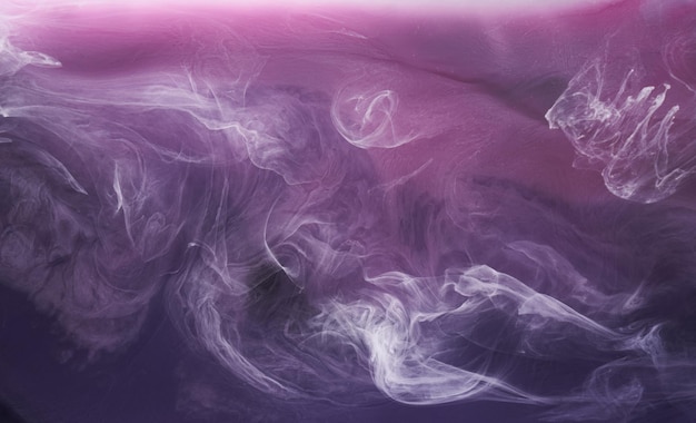 Fumée violette sur fond d'encre noire, brouillard coloré, mer océan violet tourbillonnante abstraite, pigment de peinture acrylique sous l'eau