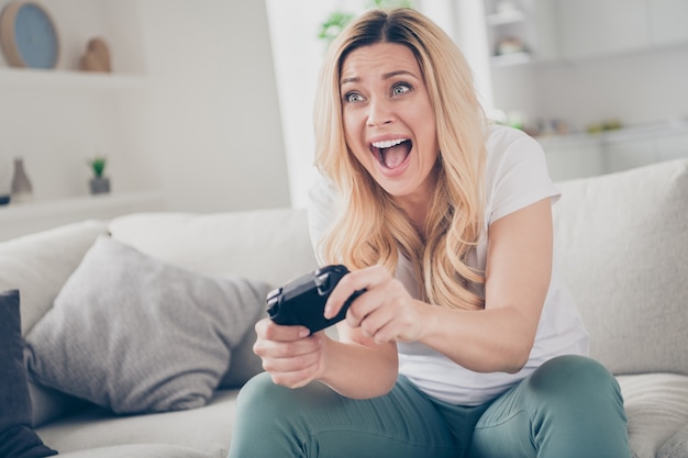 gai drôle dame s'asseoir confortable jouer à des jeux vidéo