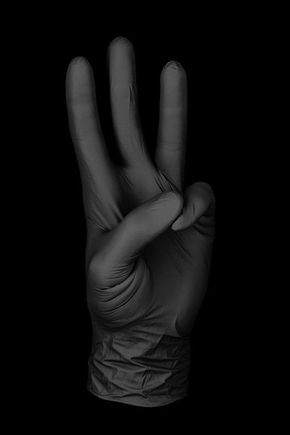 Photo gant noir à trois doigts / gant isolé fond noir