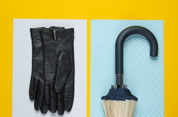 Photo gants en cuir, crochet parapluie sur une surface jaune créative