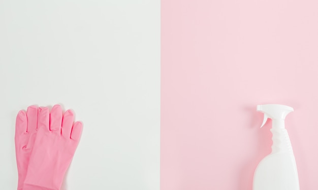 Photo des gants roses et un vaporisateur. concept de nettoyage et d'entretien ménager. mise à plat créative minimale. rose et blanc