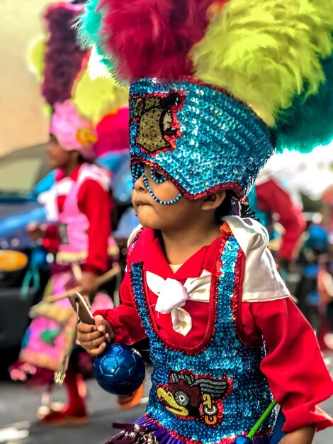 Un garçon en costume apprécie le carnaval en ville.