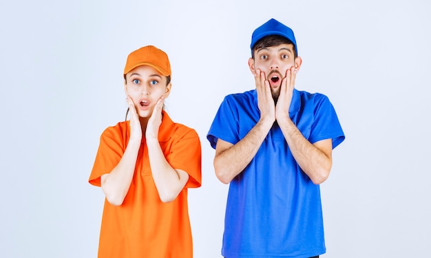 Un garçon et une fille en uniforme bleu et jaune ont l'air effrayés et terrifiés.