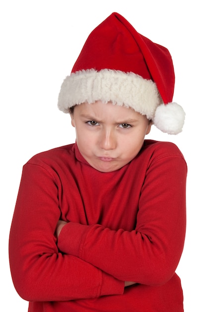 Garçon fronçant avec Bonnet de Noel isolé sur fond blanc