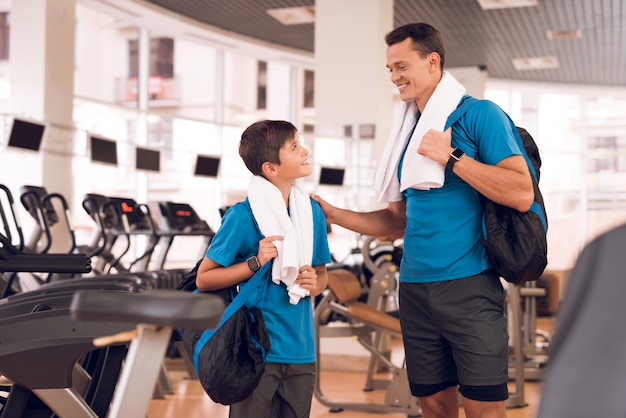 Un garçon avec papa est venu au gymnase ensemble.