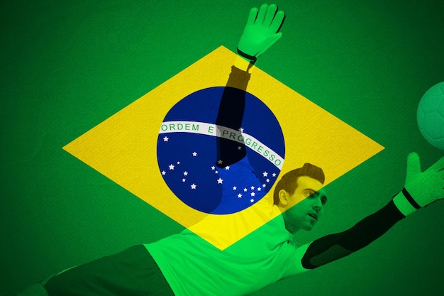 Gardien de but en jaune faisant un arrêt contre le football aux couleurs brésiliennes