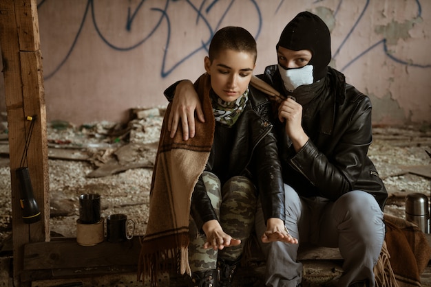 Un gars et une fille dans un bidonville sont assis ensemble, le roman de l'Apocalypse