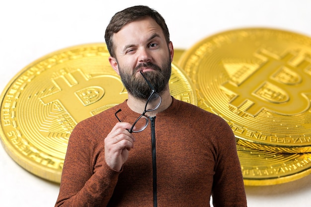Un gars pensif avec une barbe et des lunettes sur fond de Bitcoin Penser à la question