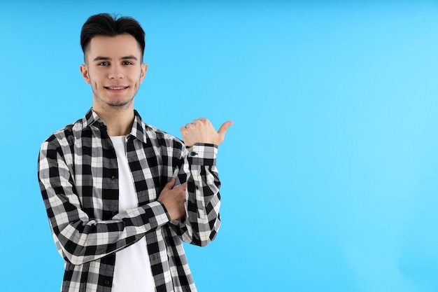 Gars séduisant en chemise sur fond bleu