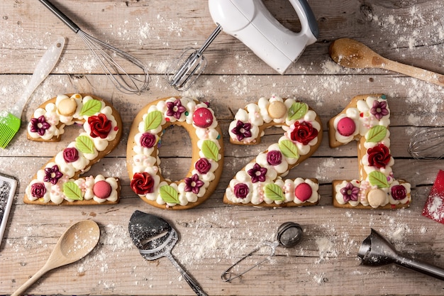 Gâteau 2021 décoré de fleurs sur bois.