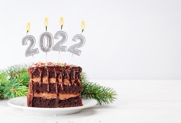 Gâteau au chocolat de Noël avec des bougies allumées numéro 2022