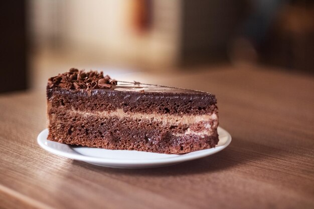 Gâteau au chocolat sur une plaque blanche sur une table en bois