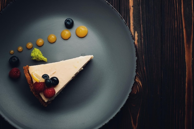 Gâteau au fromage avec des baies sur un fond en bois