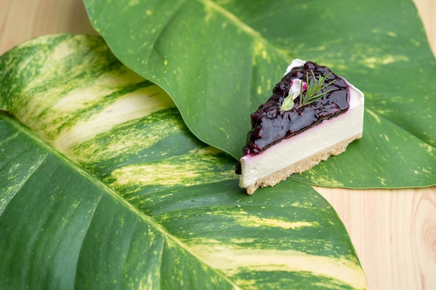 Gâteau au fromage Burberry sur feuilles vertes à table