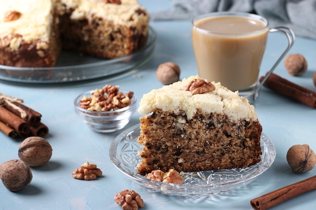 Gâteau aux miettes fait maison avec des noix et de la cannelle en plaque sur une surface bleu clair