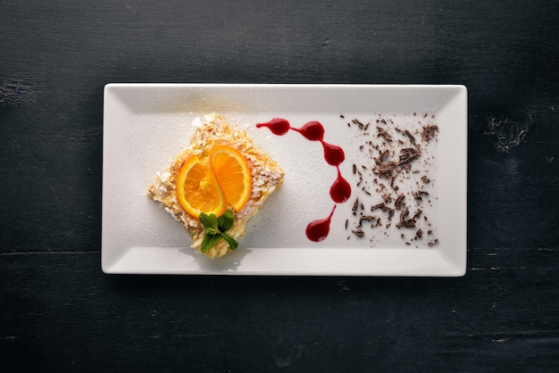 Gâteau en couches au goût d'orange Sur un fond en bois Espace libre pour votre texte Vue de dessus