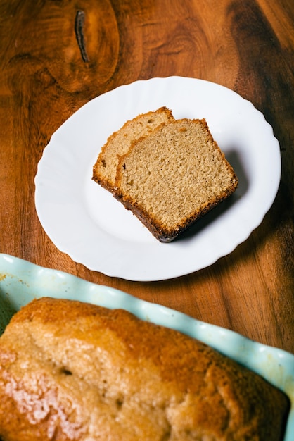 Gâteau éponge fait maison dans un moule en céramique bleu sur une table en bois