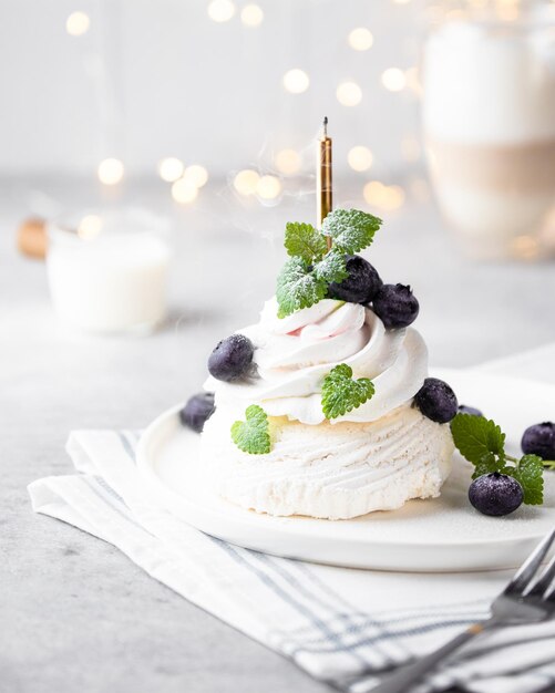 Gâteau meringué à la crème sur fond blanc dans un intérieur moderne Le gâteau est décoré de menthe