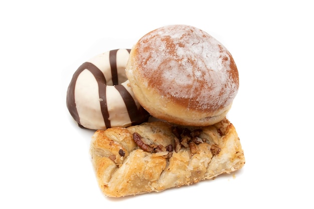 Gâteau nature morte. Beignet, beignet berlinois (beignet allemand) et pâte feuilletée torsadée sucrée, isolée sur blanc