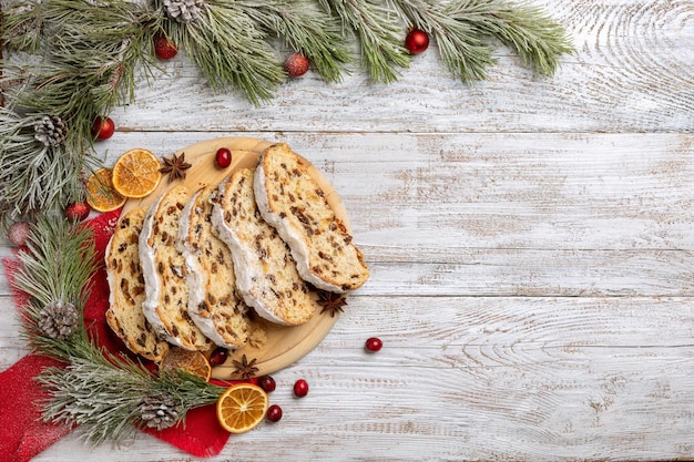 gâteau de noël volé sur une table en bois clair avec brin d'épinette. vue de dessus avec espace pour le texte