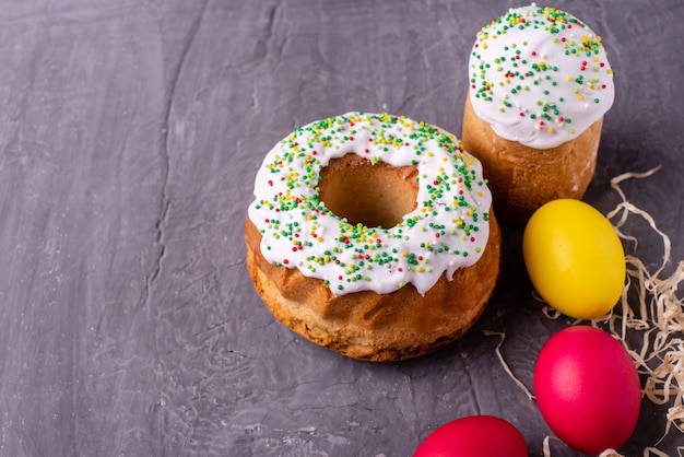 Gâteau de Pâques et oeufs colorés sur fond sombre