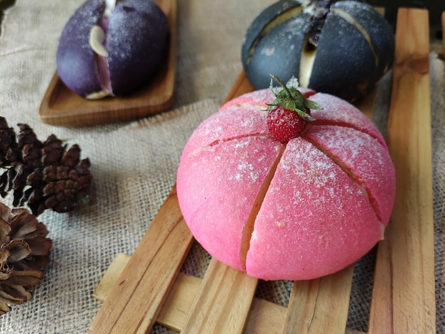 Un gâteau rose avec une fraise dessus