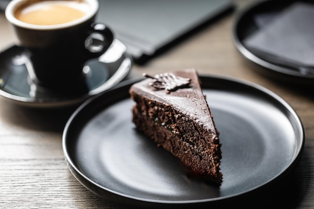 Un gâteau Sacher avec du café sur la table du café.