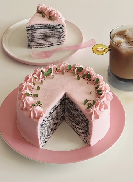 Un gâteau avec une tranche découpée et une tasse de café sur la table.