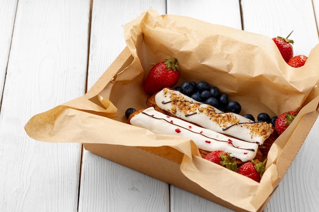 Gâteaux éclair frais dans une boîte en carton