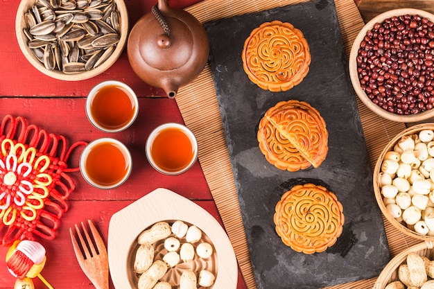 Gâteaux de lune traditionnels sur le réglage de la table avec une tasse de thé.