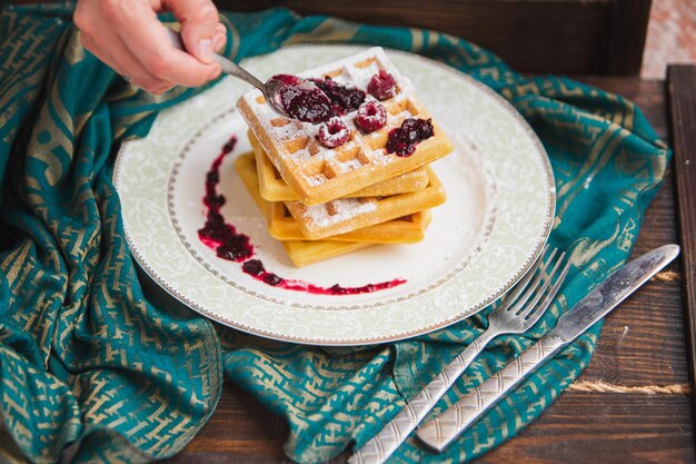 Photo des gaufres belges aux baies sont versées avec de la confiture