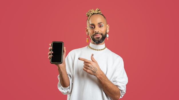 Gay afro-américain utilise un smartphone isolé sur rose