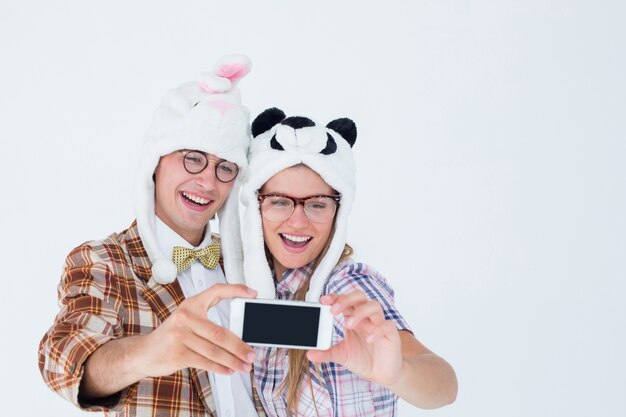 Geek hipster couple prenant selfie avec téléphone intelligent