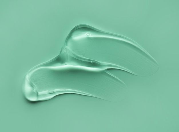 Gel liquide cosmétique tache gouttes texture fond gris vert