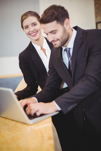 Gens d'affaires utilisant un ordinateur portable au comptoir