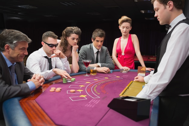 Les gens assis à table en jouant au poker