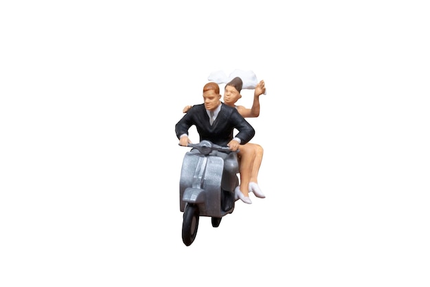 Des gens en miniature Un couple sur une moto isolé sur un fond blanc