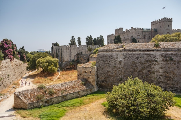 Les gens qui marchent autour des murs du château médiéval dans la vieille ville de l'île de Rhodes Grèce