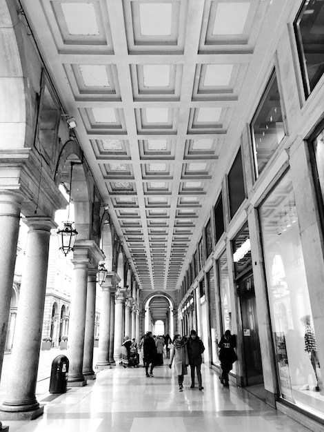 Des gens qui marchent dans le couloir du bâtiment.