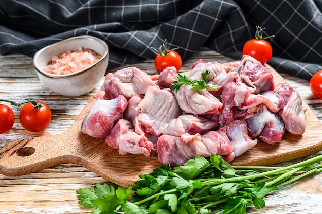 Gésiers de poulet crus crus, estomac sur une planche à découper. table en bois. Vue de dessus.