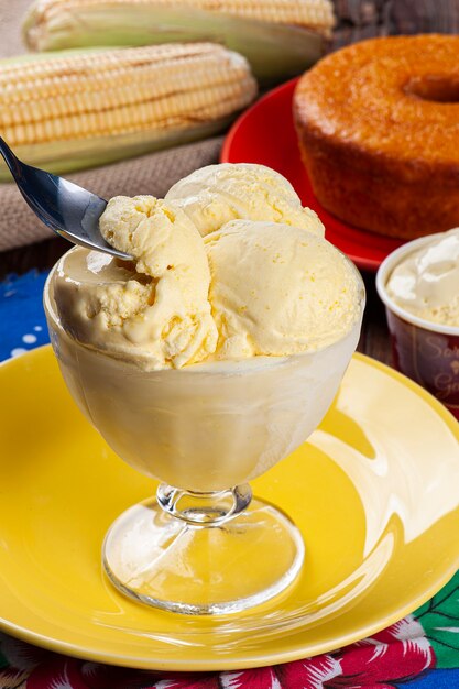 Glace au maïs dans un bol en verre. Il est écrit "crème glacée" en portugais sur le pot à côté