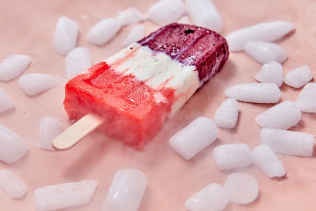 Glace sucrée maison aux petits fruits sur un bâton avec des tranches