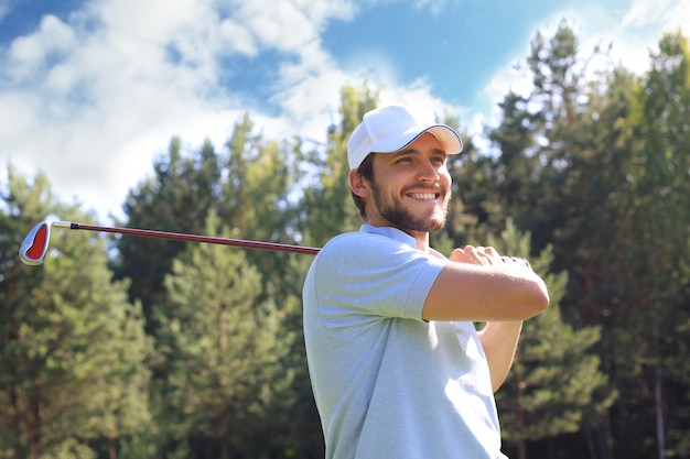 Le golfeur frappe un coup de fairway vers le club house.