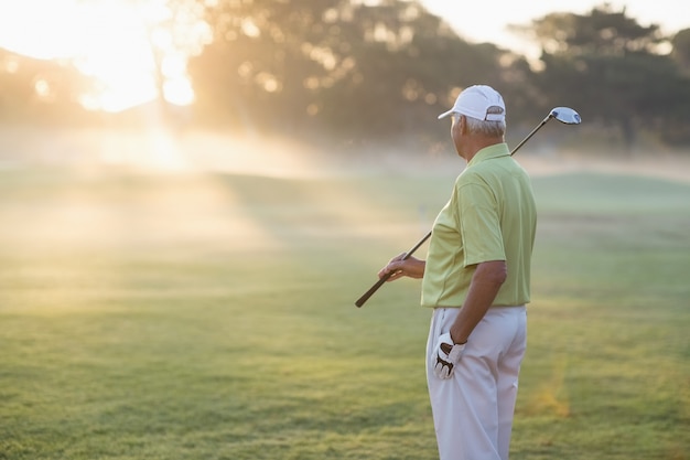 Golfeur mature homme debout sur le terrain