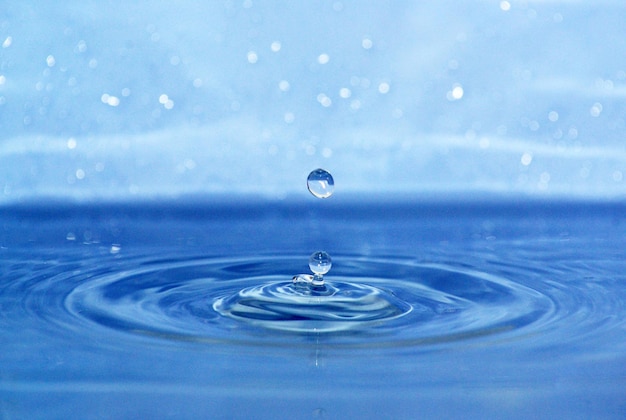 La goutte d'eau transparente ronde tombe vers le bas