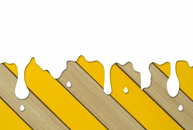 Des gouttelettes de liquide ou d'eau blanches s'écoulant diagonalement sur une planche de bois jaune et brune