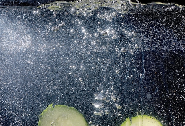 Gouttes d'eau sur le concombre mûr. Fond de légumes frais avec espace de copie pour votre texte. Concept végétalien et végétarien.