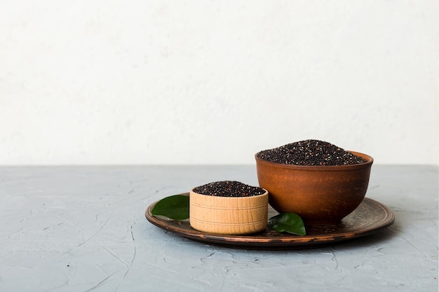 Graines de quinoa dans un bol sur fond coloré Kinwa sain dans un petit bol Superaliment sain