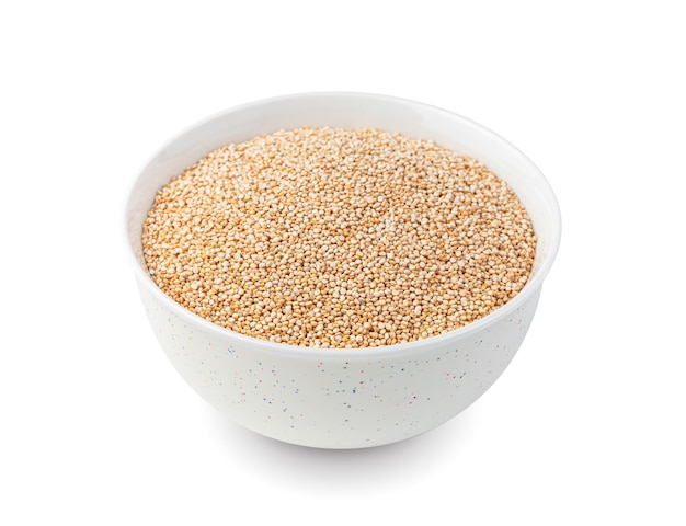 Les graines de quinoa utiles dans une tasse blanche sont isolées sur blanc Gros plan vue latérale Alimentation saine